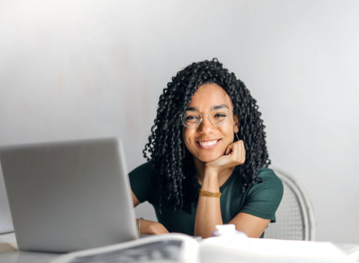 Happy black woman with laptop