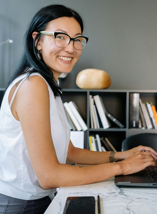 Smiling woman working at a laptop