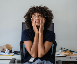 Black woman with her head in her hands
