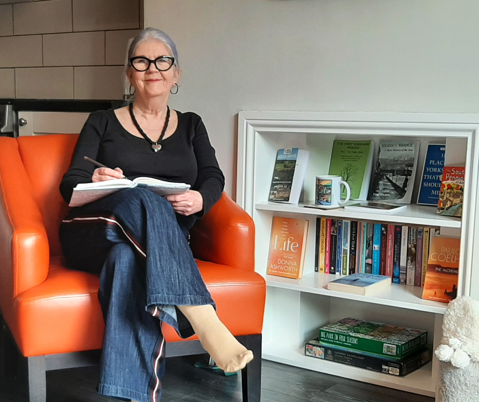 Lorraine McReight sitting in an orange chair