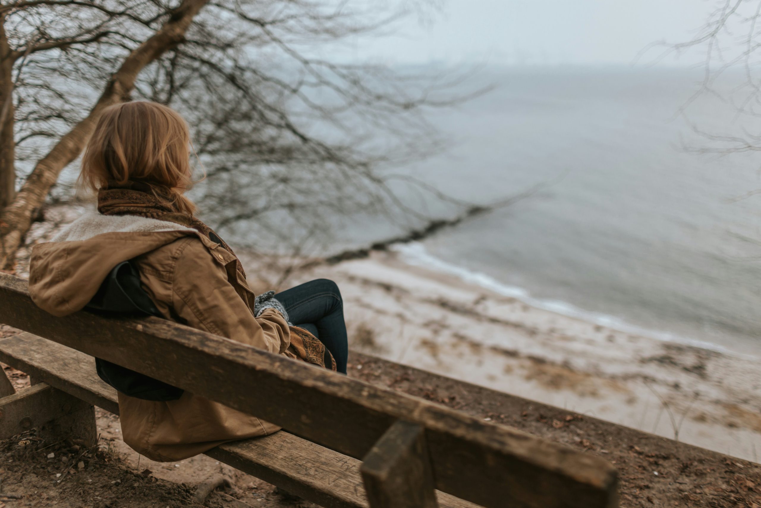 Woman day dreaming by a lake