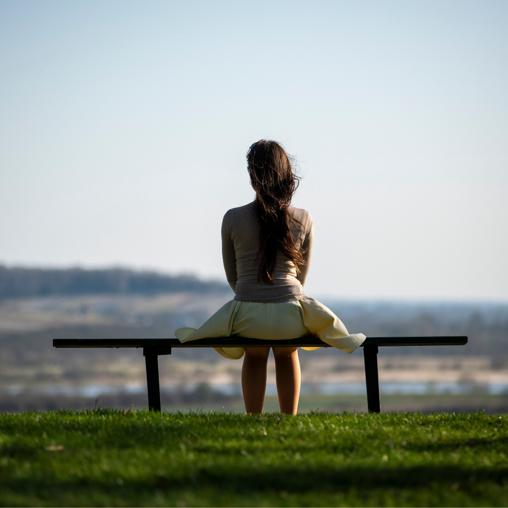 Woman sitting alone on a bench